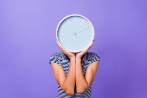 A woman with a wall clock on her face